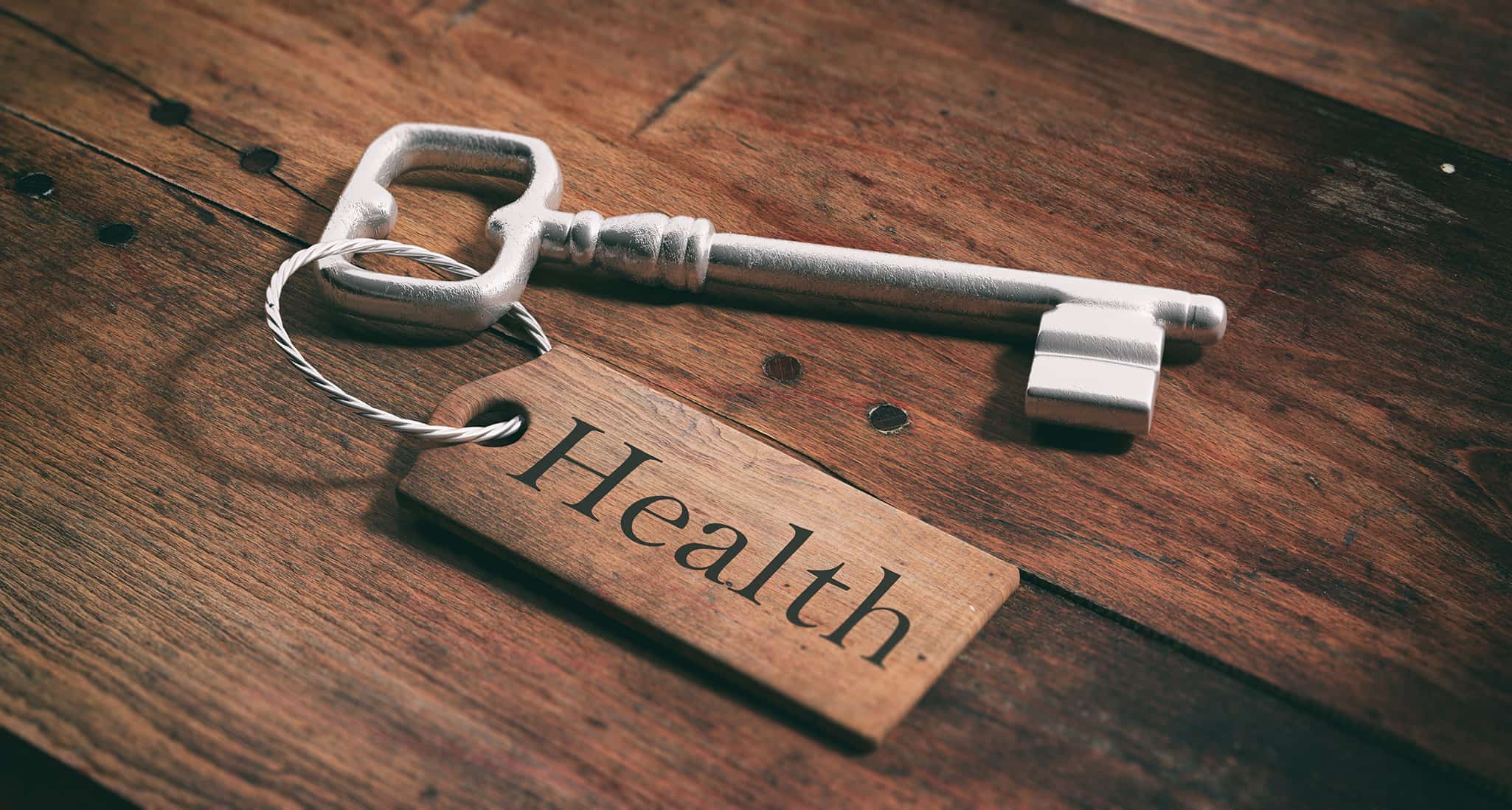 old key with tag health on a wooden background 3d illustration